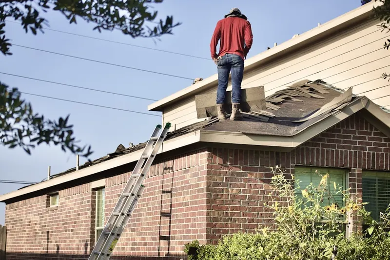 Professional roofer working on a residential roof in Latimer